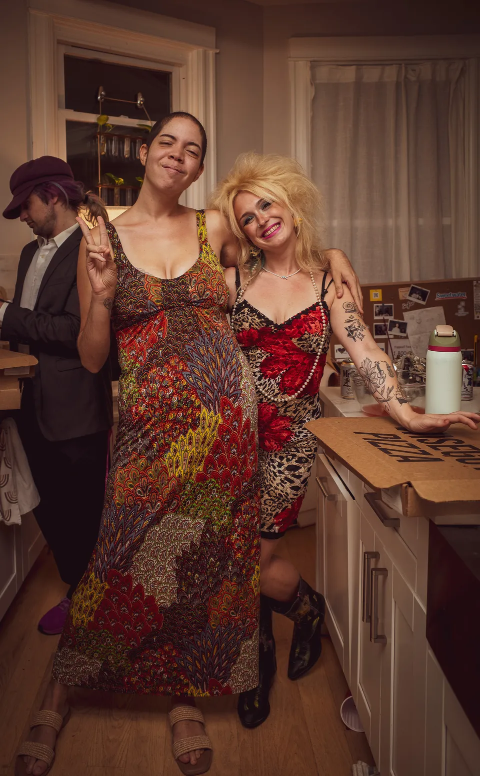 Friends laughing together in the kitchen