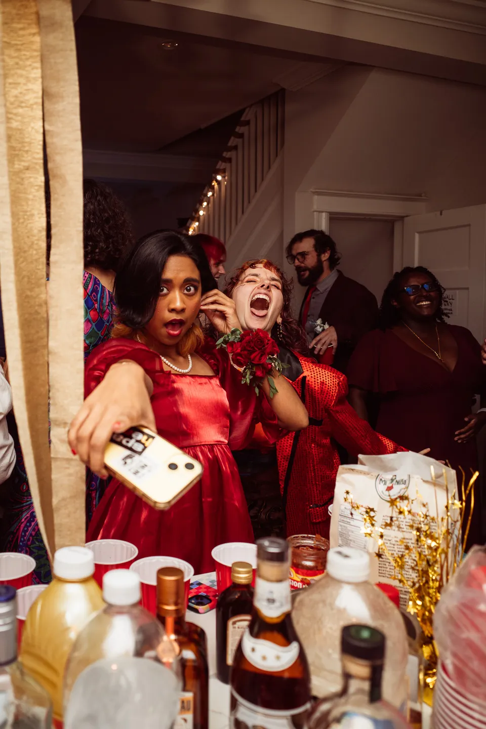 Partygoers taking a selfie at the drinks table
