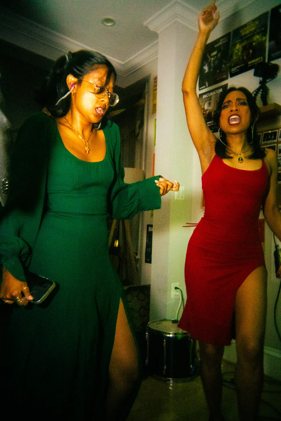 Two women in green and red dresses dancing