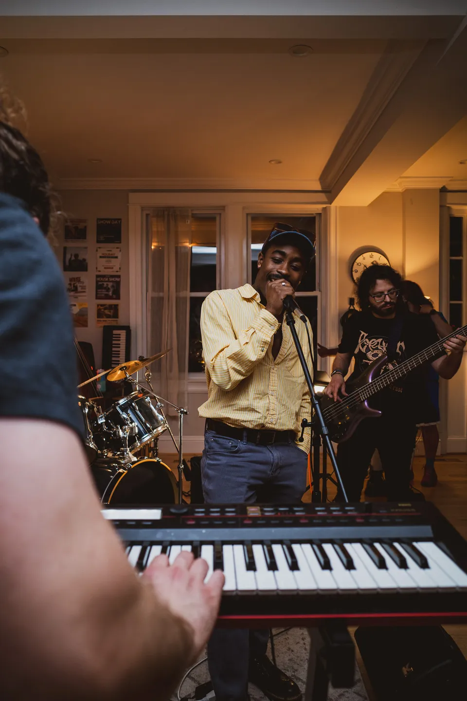 Band playing behind a keyboard in the front room