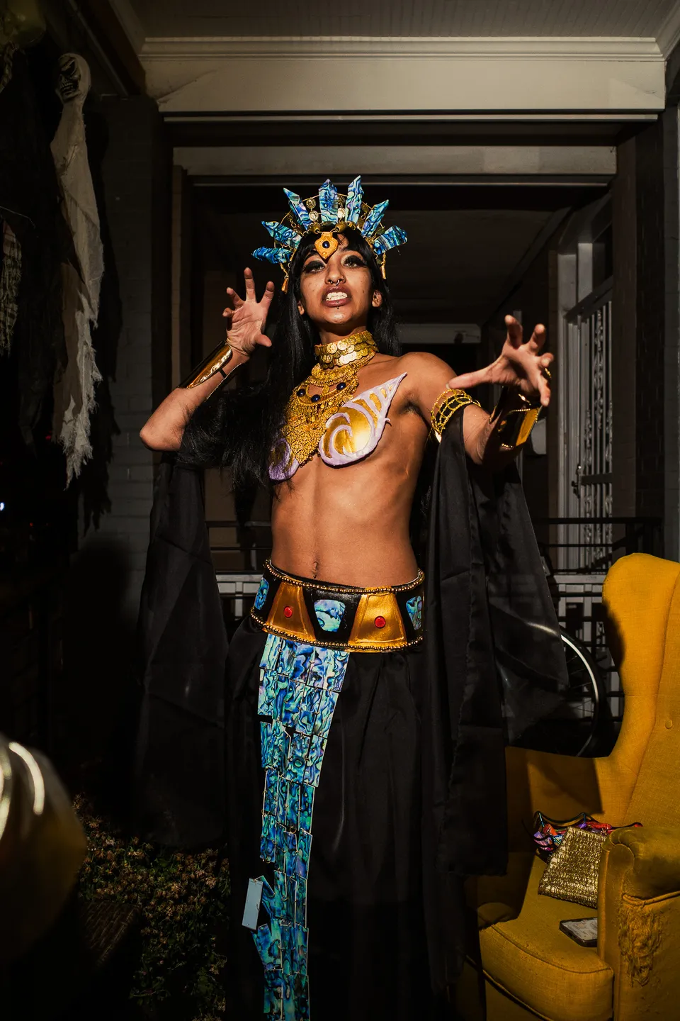 Performer in a gold headdress and costume