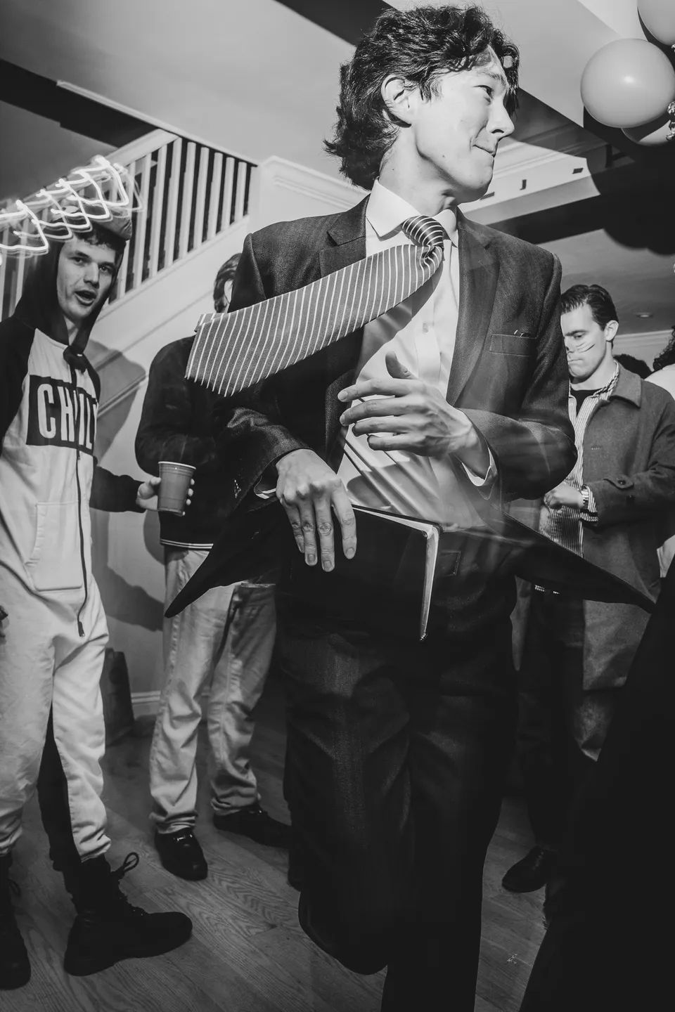 Dancer in a suit mid-move, in black and white
